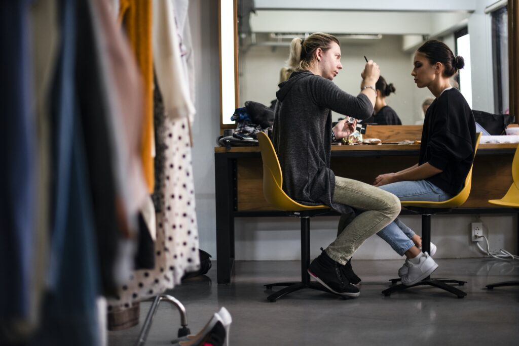 Makeup artist applying makeup onto model